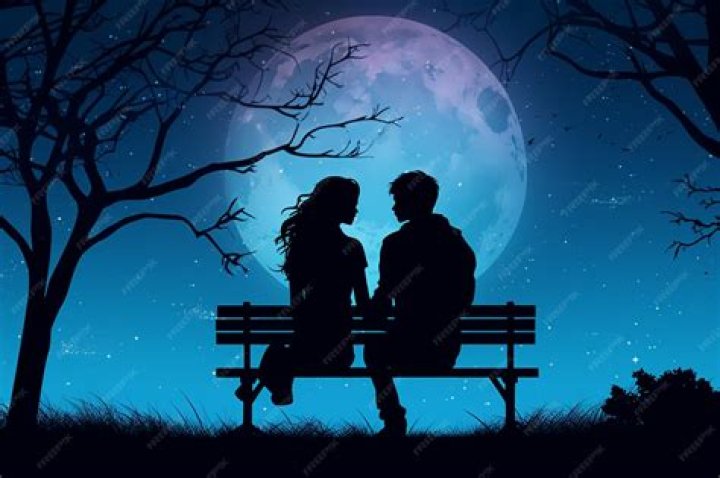 a man and woman sitting on a bench near the water