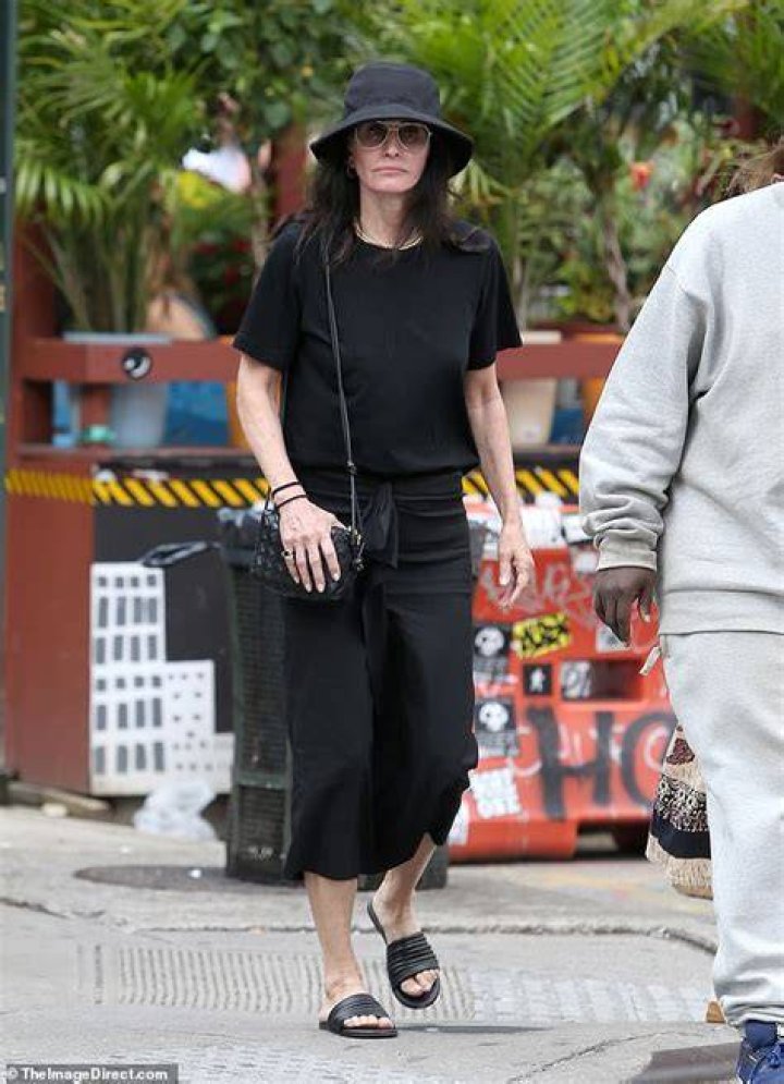 Cute dress: The Friends alum, 59, looked chic in a summery black midi dress with a dropped waist and short sleeves