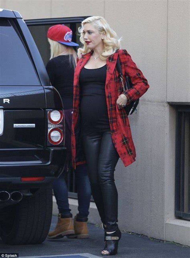 Gwen Stefani parades her VERY large bump in clingy top and tartan coat